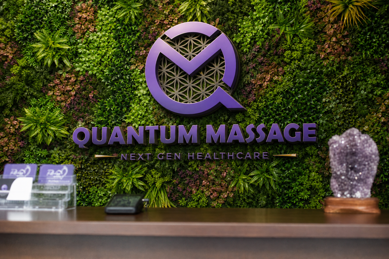 Quantum Massage reception desk with green plant wall